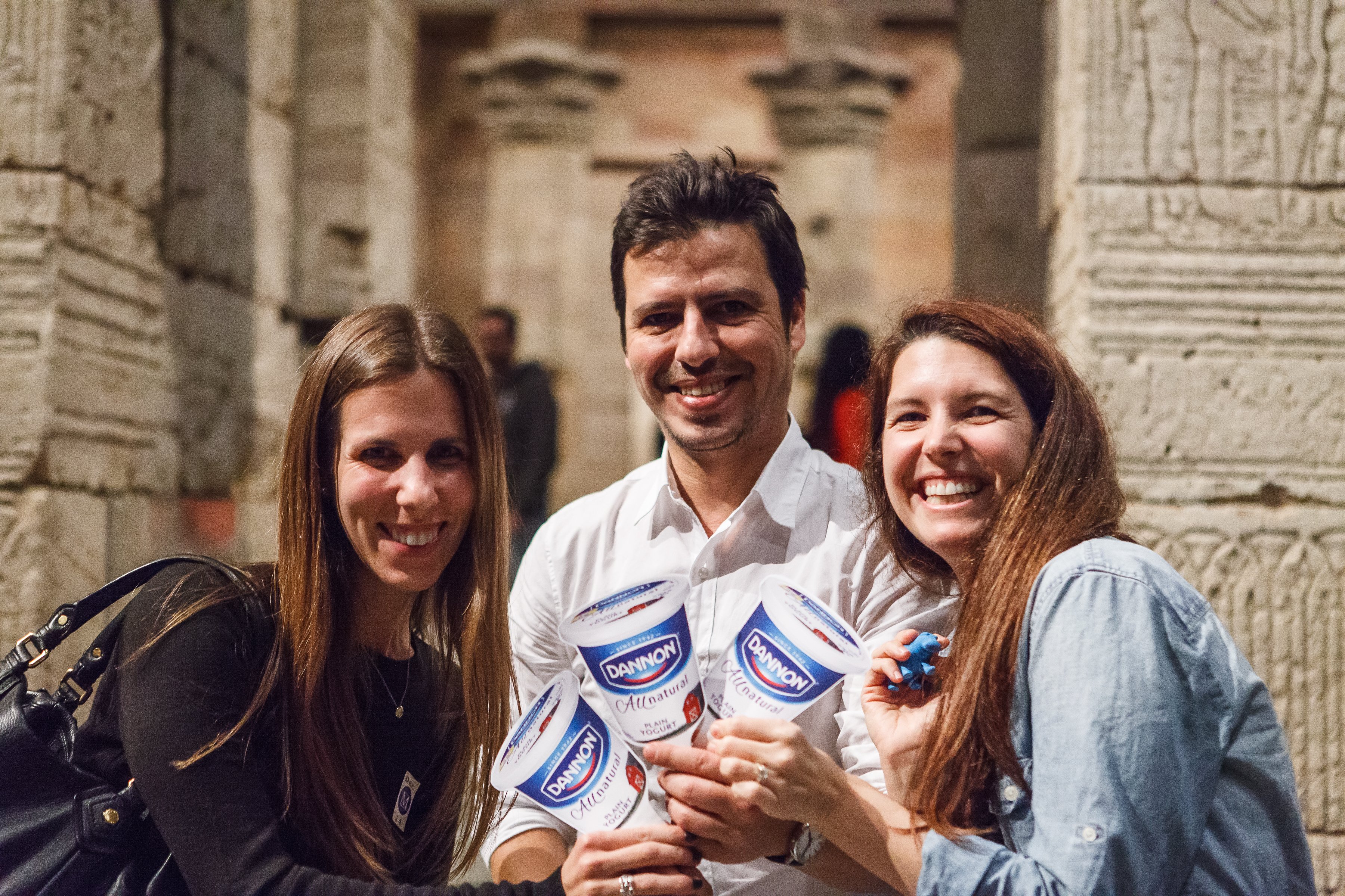 Dannon's team is all smiles with their yogurt cups on sticks.